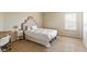 Bright bedroom featuring white bedding, a wooden side table, and ample natural light at 13234 Amundson Dr, Carmel, IN 46074