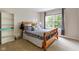 Cozy bedroom featuring natural light from a large window and a decorative gray and white bedspread at 13234 Amundson Dr, Carmel, IN 46074