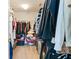 Walk-in closet filled with clothes, storage containers, and ample hanging space at 13234 Amundson Dr, Carmel, IN 46074