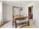 Elegant dining area features a rustic wood table, bench seating and modern light fixture complemented by neutral walls at 13234 Amundson Dr, Carmel, IN 46074
