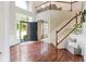 Stunning two-story foyer showcasing hardwood floors, a staircase, and abundant natural light creating an open feel at 13234 Amundson Dr, Carmel, IN 46074