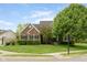 Traditional brick home with a well-manicured lawn, mature trees, and manicured hedges enhancing curb appeal at 13234 Amundson Dr, Carmel, IN 46074