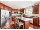 Updated kitchen features stainless steel appliances, an island with bar seating, and wood floors at 13234 Amundson Dr, Carmel, IN 46074
