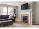 Comfortable living room features a fireplace, a large TV, and a plush purple couch at 13234 Amundson Dr, Carmel, IN 46074