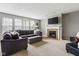 Comfortable living room features a large sectional, fireplace, and bright windows providing ample natural light at 13234 Amundson Dr, Carmel, IN 46074