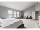 Bright main bedroom featuring large windows, neutral carpet, and comfortable seating area at 13234 Amundson Dr, Carmel, IN 46074