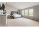 Spacious main bedroom with large windows providing natural light and a neutral color scheme at 13234 Amundson Dr, Carmel, IN 46074