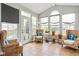 Bright sunroom with wicker chairs, potted plants, and lots of natural light from multiple windows at 13234 Amundson Dr, Carmel, IN 46074