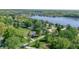 An aerial view shows homes on the lake with mature trees and green yards on a sunny day at 1328 Toner Dr, Anderson, IN 46012