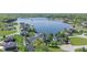 Aerial view of homes on lake, featuring boat docks, well-manicured lawns, and lush landscaping at 1328 Toner Dr, Anderson, IN 46012