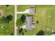 An aerial view shows a home with a detached garage and a long driveway on a grassy lot at 1328 Toner Dr, Anderson, IN 46012