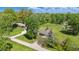 Aerial view of the property showcasing lush landscaping and mature trees at 1328 Toner Dr, Anderson, IN 46012