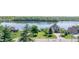 An aerial view shows luxurious lakeside homes surrounded by mature trees and well manicured lawns at 1328 Toner Dr, Anderson, IN 46012