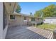 Backyard of the home with wooden patio deck and yard at 1328 Toner Dr, Anderson, IN 46012