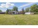 Rear view of the home showing large lot with detached garage at 1328 Toner Dr, Anderson, IN 46012