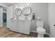 Bathroom featuring a double sink vanity, toilet, and sleek modern fixtures and lighting at 1328 Toner Dr, Anderson, IN 46012