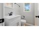 Cozy powder room featuring a vanity with modern faucet, a toilet, and simple elegance at 1328 Toner Dr, Anderson, IN 46012