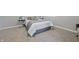 Well-lit bedroom with plush carpet, a neatly made bed with decorative pillows, and subtle decor accents at 1328 Toner Dr, Anderson, IN 46012