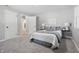 Bright bedroom with neutral walls, carpet, a comfortable bed with decorative pillows, and natural light streaming through the window at 1328 Toner Dr, Anderson, IN 46012