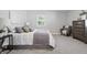Cozy bedroom with plush carpeting, a comfortable bed with decorative pillows, a window and a stylish side table at 1328 Toner Dr, Anderson, IN 46012