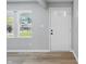 Bright entryway featuring wood flooring, neutral walls, and a white door and trim at 1328 Toner Dr, Anderson, IN 46012