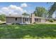 Beautifully landscaped brick ranch home with well-manicured lawn and an attached garage at 1328 Toner Dr, Anderson, IN 46012