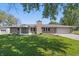 Charming brick ranch home featuring a lush green lawn and attached two-car garage at 1328 Toner Dr, Anderson, IN 46012