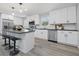 Contemporary kitchen boasting white cabinets, stainless steel appliances, black countertops and stylish island with bar stool seating at 1328 Toner Dr, Anderson, IN 46012