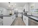 Spacious kitchen featuring white cabinetry, stainless steel appliances and a large island with seating, all illuminated by natural light at 1328 Toner Dr, Anderson, IN 46012