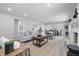 Open-concept living room with stylish decor, fireplace, and a view into the dining area at 1328 Toner Dr, Anderson, IN 46012