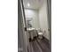 Powder room features a sleek pedestal sink, contemporary toilet, and wood-look floors at 13460 Dewpoint Ln, Fishers, IN 46037