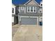 Attached two-car garage with gray door and driveway at 13460 Dewpoint Ln, Fishers, IN 46037
