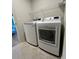 Bright laundry room with modern LG washer and dryer and wire shelving at 13460 Dewpoint Ln, Fishers, IN 46037