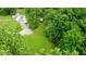 Aerial view of a beautiful property featuring lush lawn, wooded areas, and winding driveway at 1409 S Northview Dr, Martinsville, IN 46151