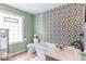 Modern bathroom with stylish tiles, bathtub, and sleek vanity at 1409 S Northview Dr, Martinsville, IN 46151