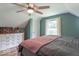Comfortable bedroom with ceiling fan and hardwood floors at 1409 S Northview Dr, Martinsville, IN 46151
