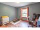Cozy room with hardwood floors, large window, and space for home office at 1409 S Northview Dr, Martinsville, IN 46151