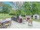 This outdoor deck features a built-in grill and cooking space, dining table, and fire pit for entertaining at 1409 S Northview Dr, Martinsville, IN 46151