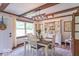 Inviting dining area features wood beams, decor, and an abundance of natural light at 1409 S Northview Dr, Martinsville, IN 46151