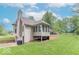 Inviting exterior of a home with a sunroom, deck, and a spacious green lawn on a sunny day at 1409 S Northview Dr, Martinsville, IN 46151