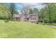 View of a unique home design and large lawn with attached garage at 1409 S Northview Dr, Martinsville, IN 46151