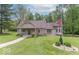 Charming home featuring a well-manicured lawn, American flag, and cozy front porch at 1409 S Northview Dr, Martinsville, IN 46151