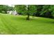 Expansive front yard featuring lush green grass, a fire pit area, and a charming two-story home at 1409 S Northview Dr, Martinsville, IN 46151
