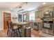 Charming kitchen with stainless appliances, island seating, and stylish light fixture at 1409 S Northview Dr, Martinsville, IN 46151