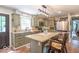 Lovely kitchen with stone countertops, island with seating, stainless steel appliances, and natural lighting at 1409 S Northview Dr, Martinsville, IN 46151