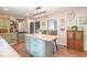 Bright kitchen with stone countertops, stainless steel fridge, and a spacious island at 1409 S Northview Dr, Martinsville, IN 46151