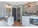 Laundry room with patterned wall, shelving, and washer and dryer at 1409 S Northview Dr, Martinsville, IN 46151