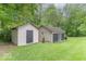 This image features two storage sheds in a well-maintained backyard at 1409 S Northview Dr, Martinsville, IN 46151
