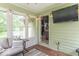 Enclosed sunroom with mounted TV and plentiful windows at 1409 S Northview Dr, Martinsville, IN 46151
