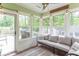Cozy sunroom with a comfortable couch, string lights, and many windows at 1409 S Northview Dr, Martinsville, IN 46151